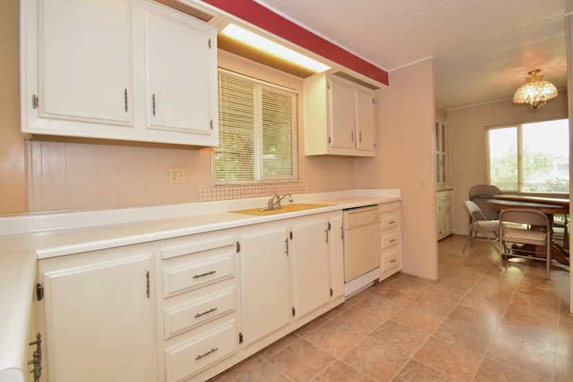 A kitchen with white cabinets

Description automatically generated