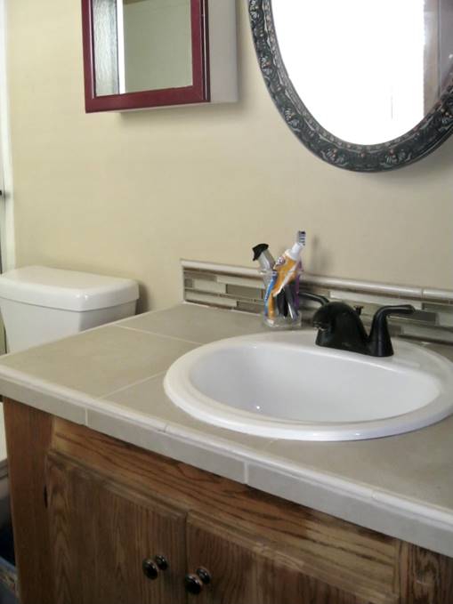 A bathroom sink with a mirror above it

Description automatically generated with medium confidence