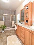 A bathroom with wooden cabinets

Description automatically generated with medium confidence
